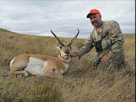 hunter posed with shot animal