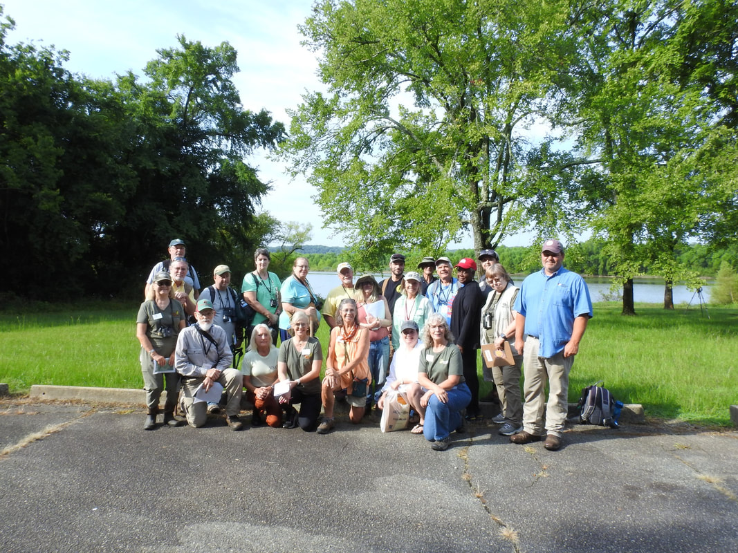 group of about 20 people posed outdoors