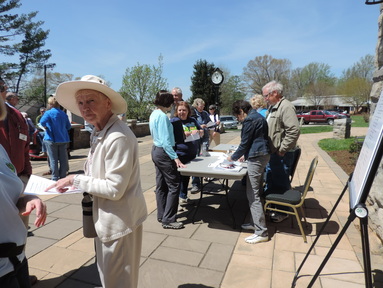 people gathered around tables at an educational event