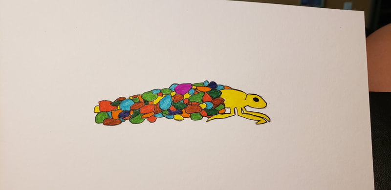 yellow caddisfly larva in case of multicolored stones