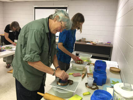 two individuals doing a craft in a classroom