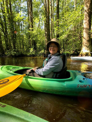 person paddling a kayak