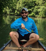 man paddling a canoe