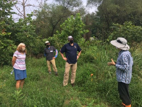 volunteers standing in a field outdoors
