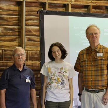 woman scholarship recipient posed with two volunteer leaders on either side