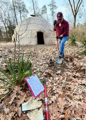 volunteer digging a hole