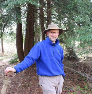 man posed outdoors in a forest